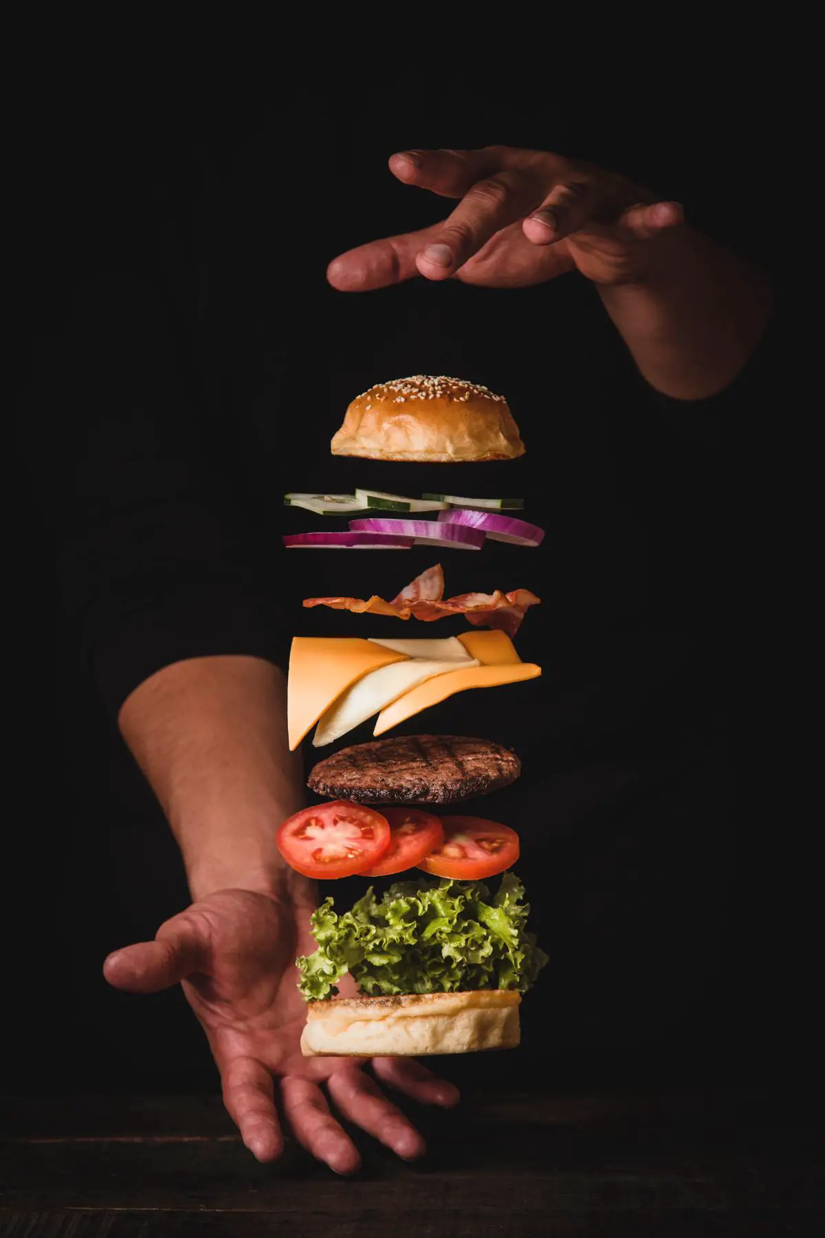 A mouth-watering image of a Big Tasty with Bacon burger, showcasing its beautiful layers of ingredients and capturing its essence as a delicious, indulgent treat.